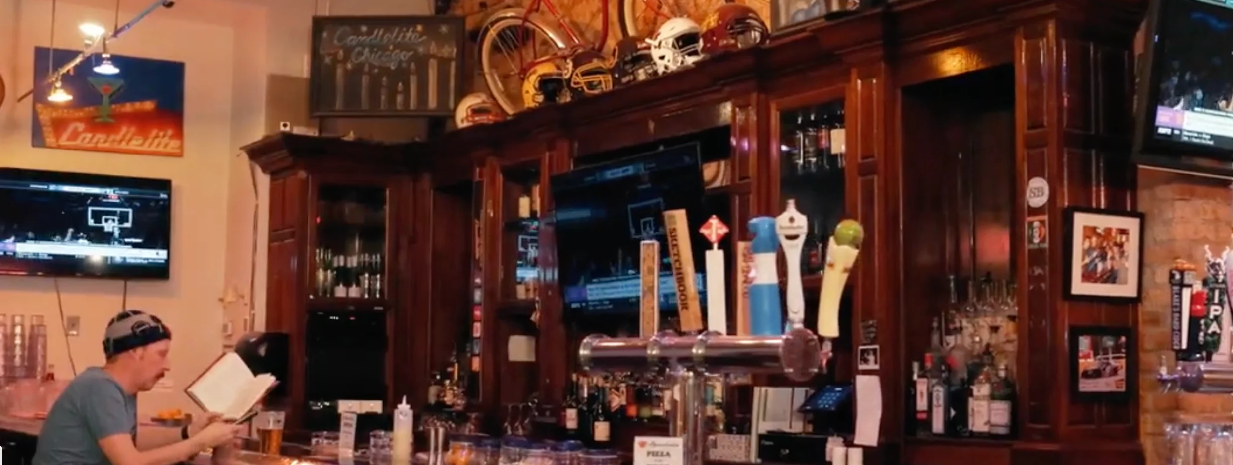 Cozy bar interior with wooden decor and sports on TV