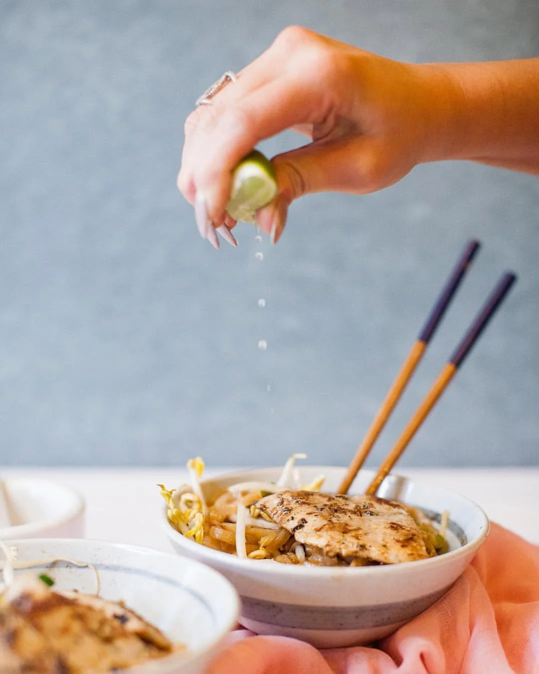 Sizzling Thai pad thai with lime and chopsticks