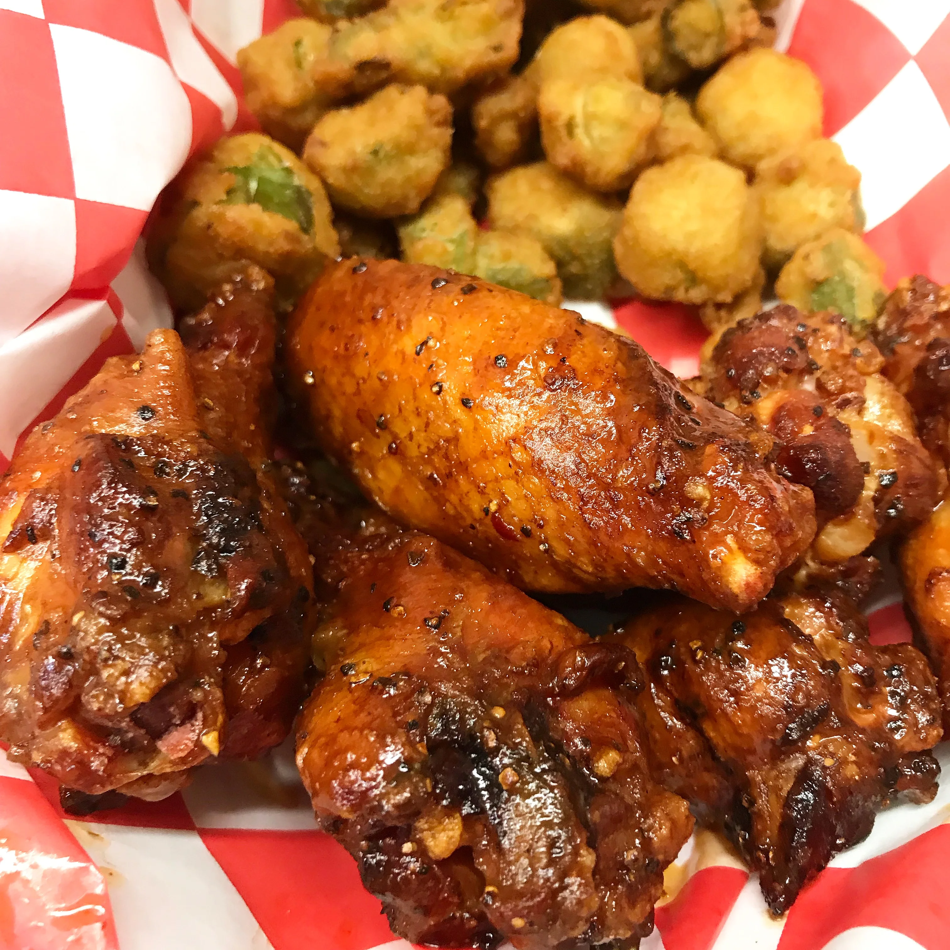 Delicious BBQ platter with ribs, chicken, and sides on a wooden table.