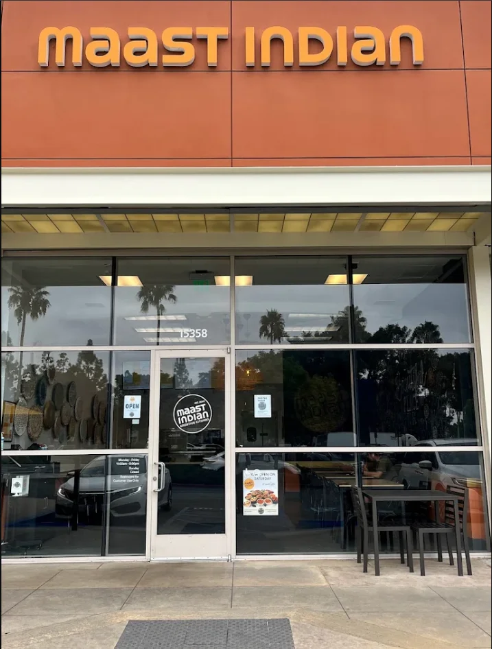 Exterior view of Maast Indian restaurant during soft opening at night