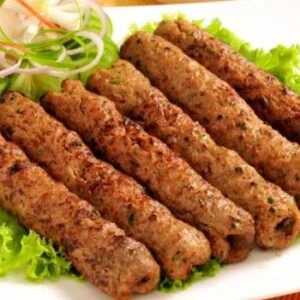 Grilled kebabs served on a bed of fresh lettuce