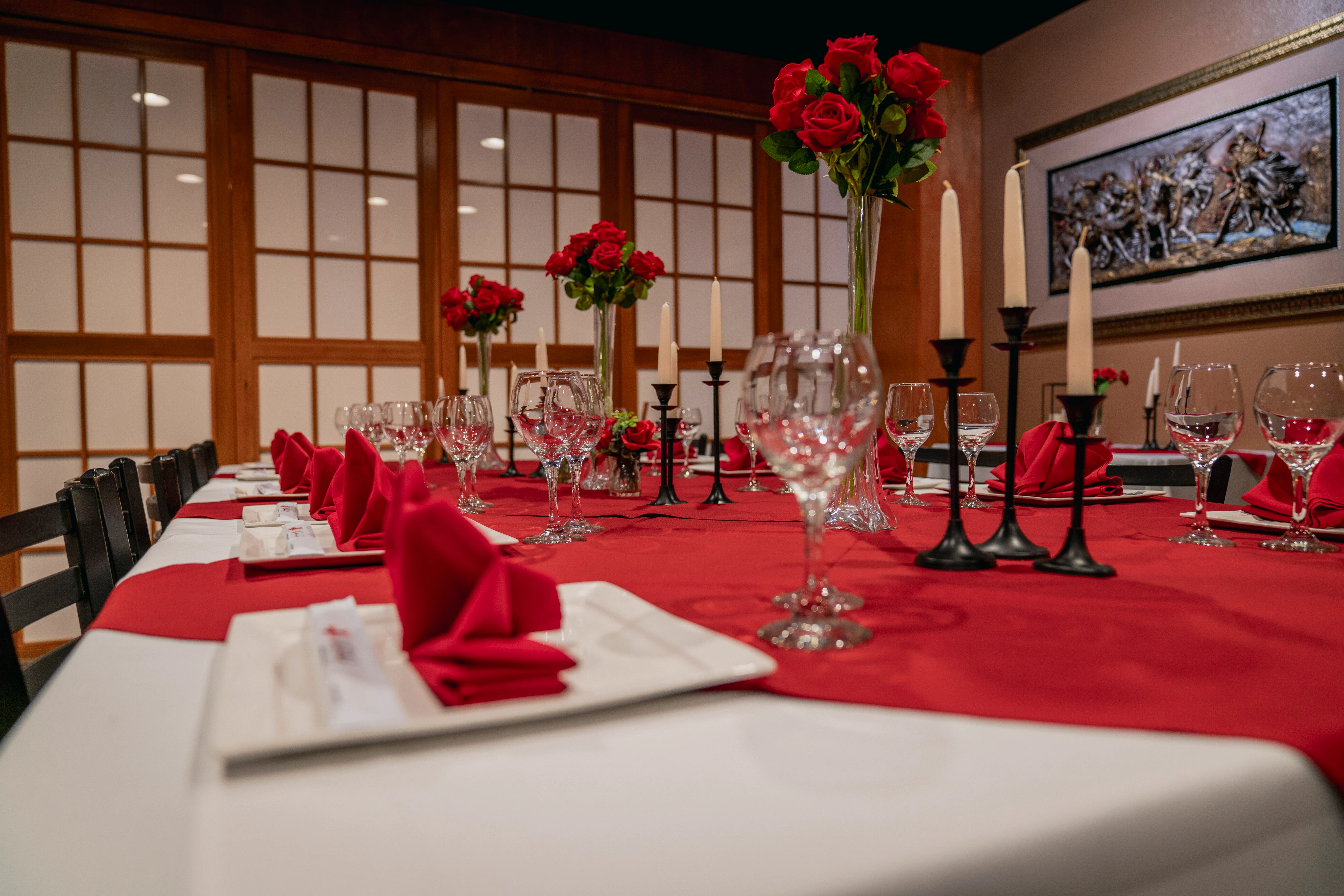 Elegant dining setup with red roses and candles