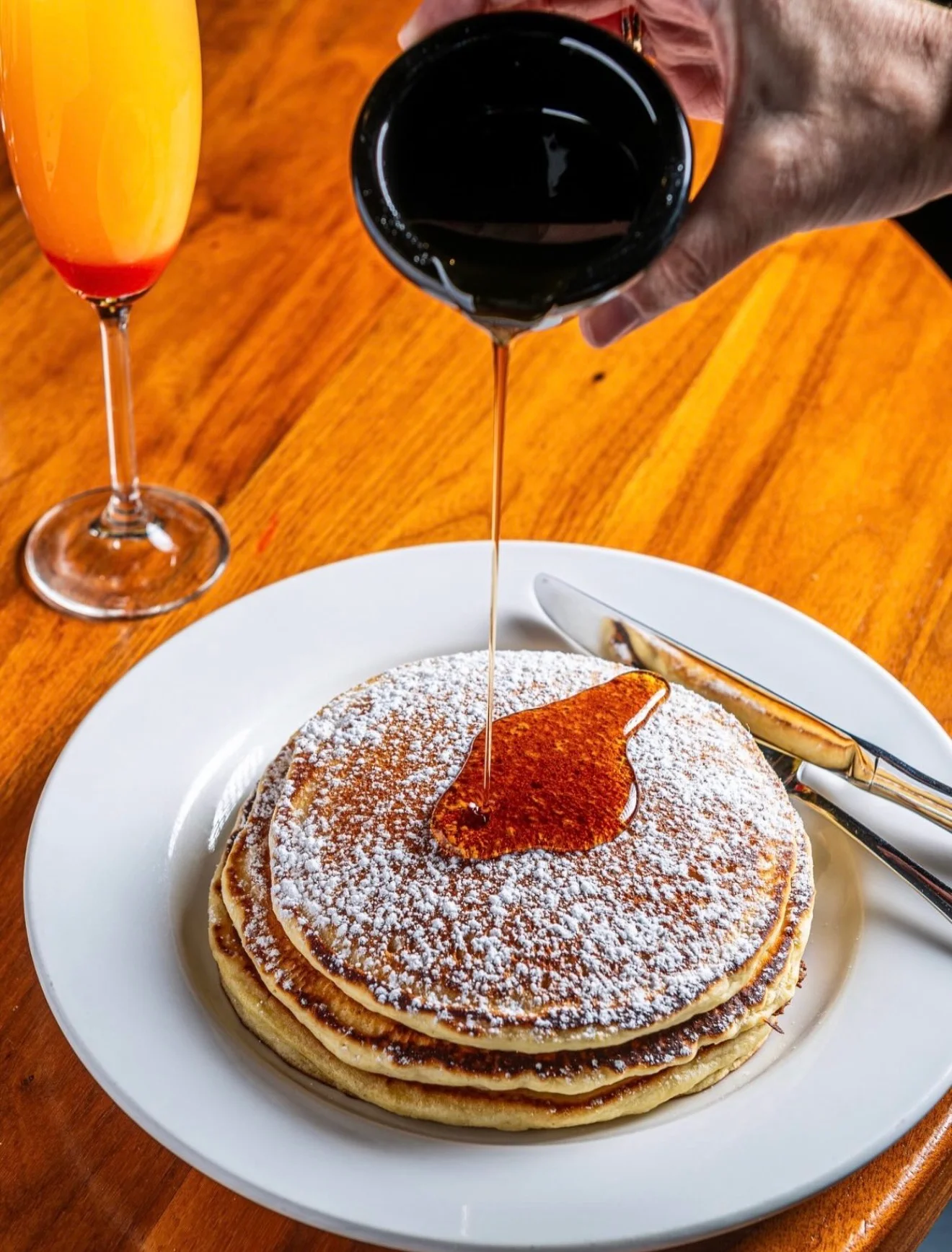 Fluffy buttermilk pancakes drizzled with syrup