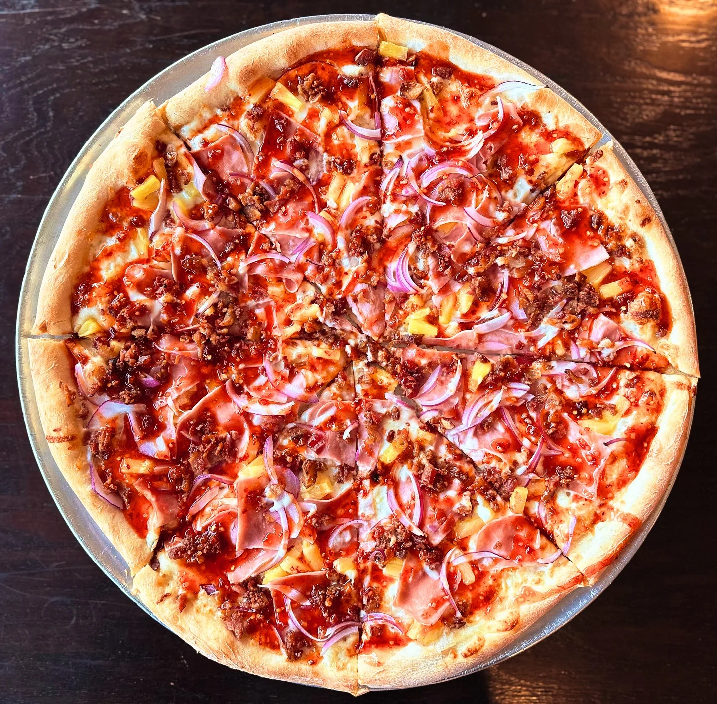 Hawaiian pizza topped with ham and pineapple