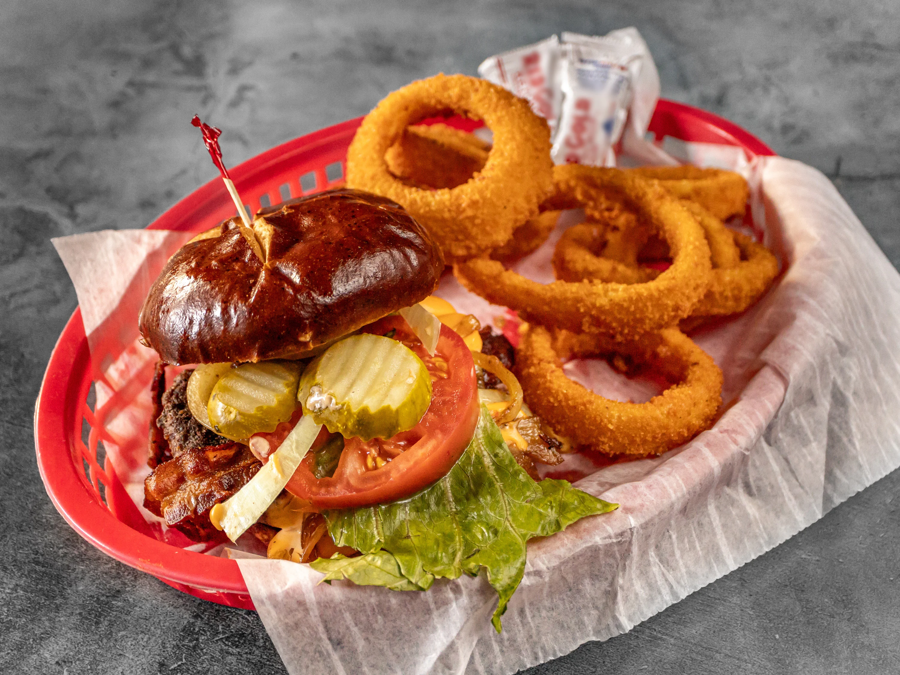Juicy American cheeseburger with onion rings