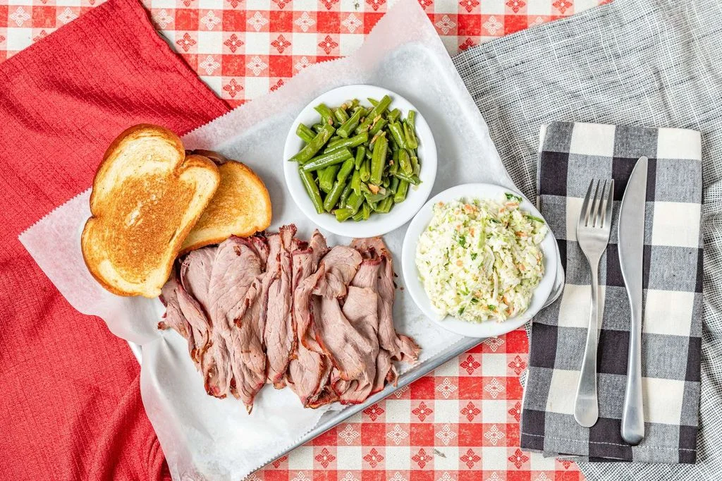 Classic Southern barbecue platter with sliced beef and sides