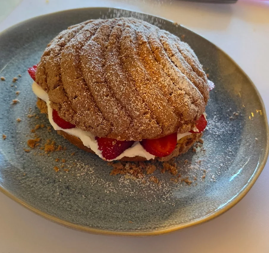 Delicious strawberry shortcake with whipped cream and powdered sugar