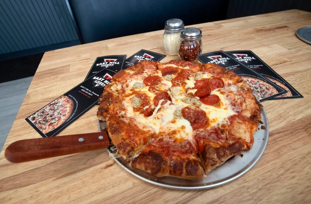 Pepperoni pizza with sausage on a restaurant plate