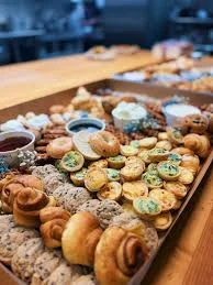 Assorted muffins and fresh fruit display for a breakfast buffet