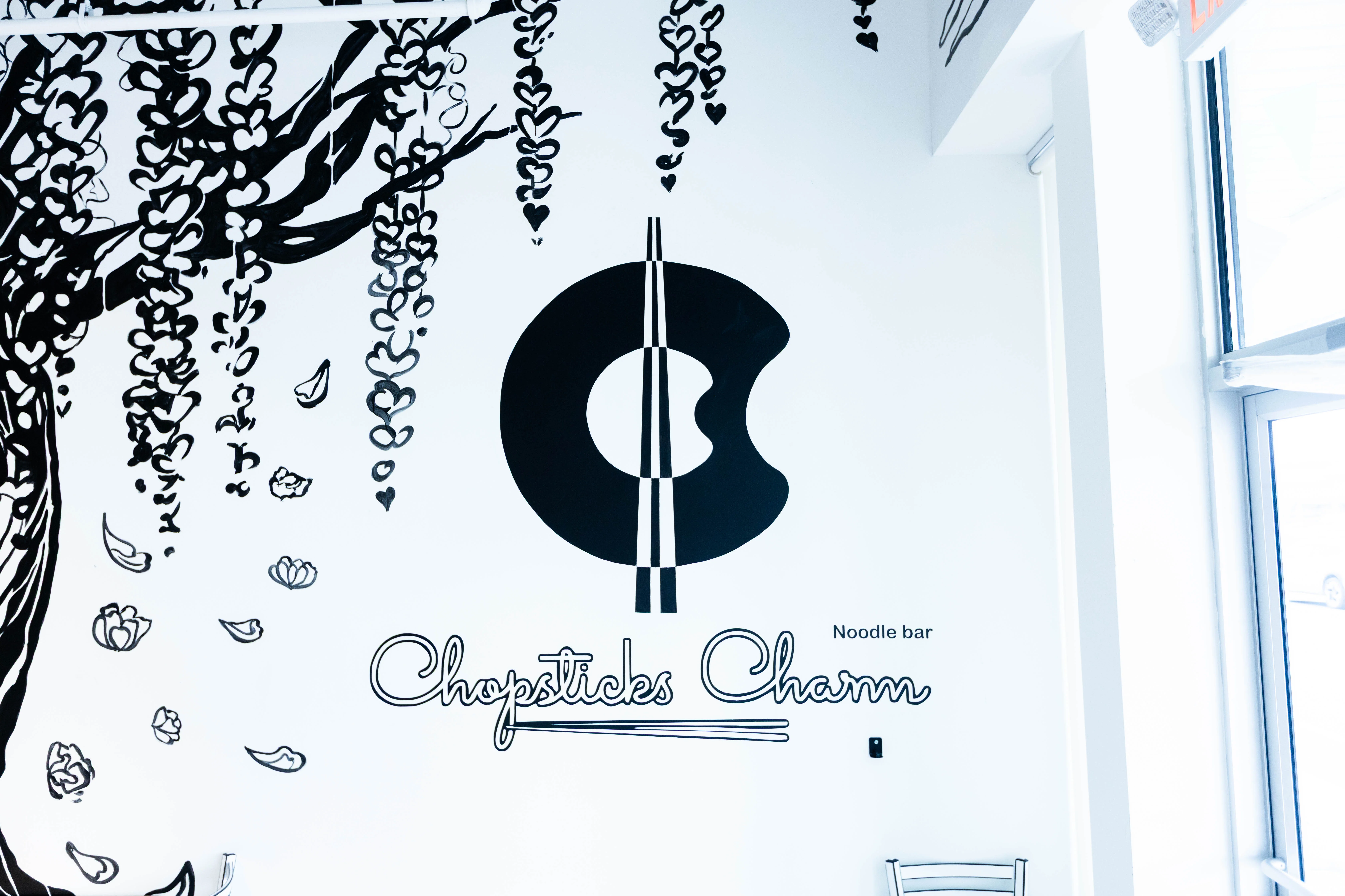  A unique dining table at Chopsticks Charm with a beautiful white, 2-D styled tree growing from its center.
