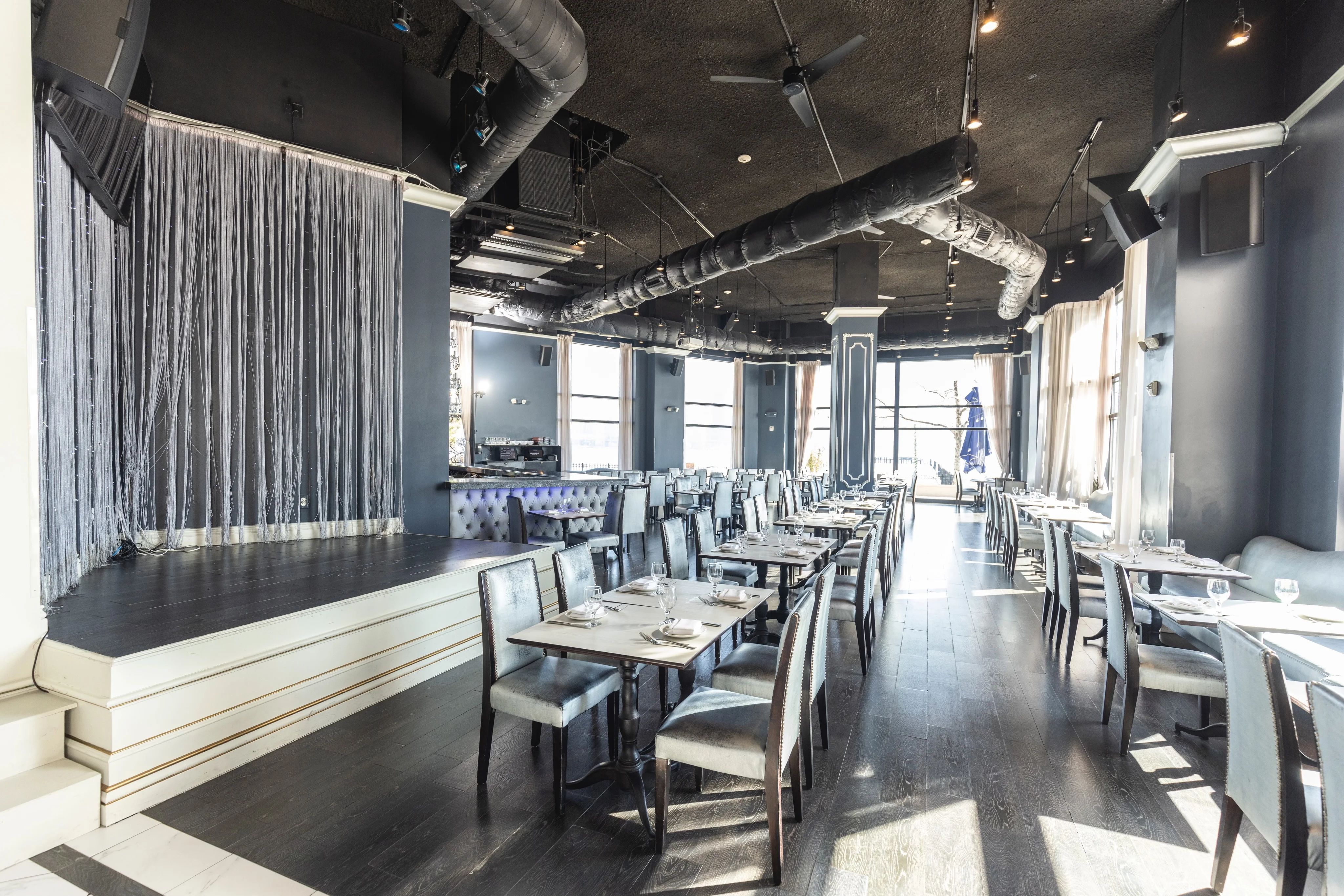 Stylish restaurant interior with elegant seating and stage area