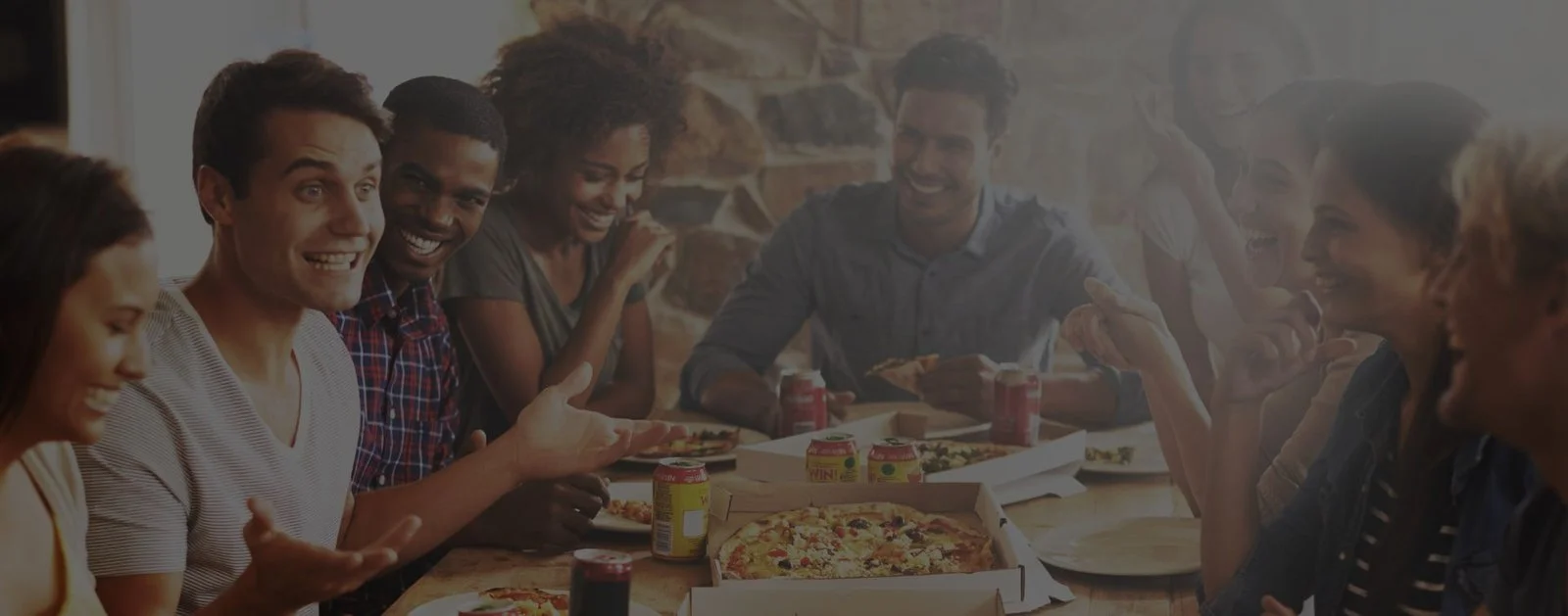Group of friends enjoying pizza at a lively gathering