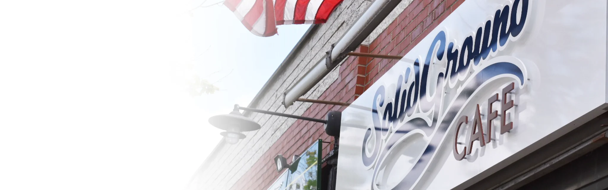 Cafe exterior with American flag and inviting signage