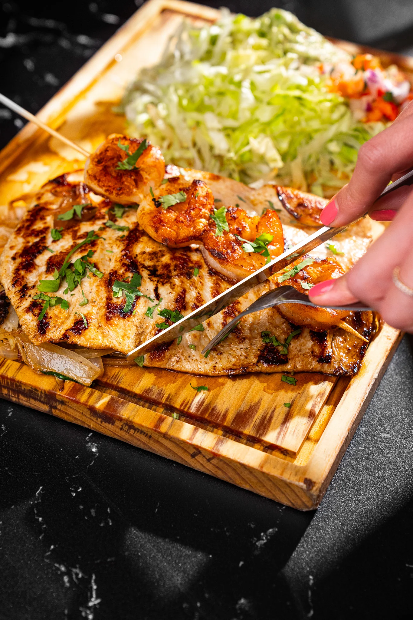 Grilled shrimp fajitas served on a wooden platter
