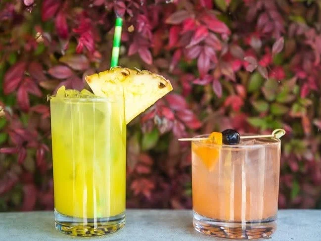 Colorful tropical cocktail garnished with a flower