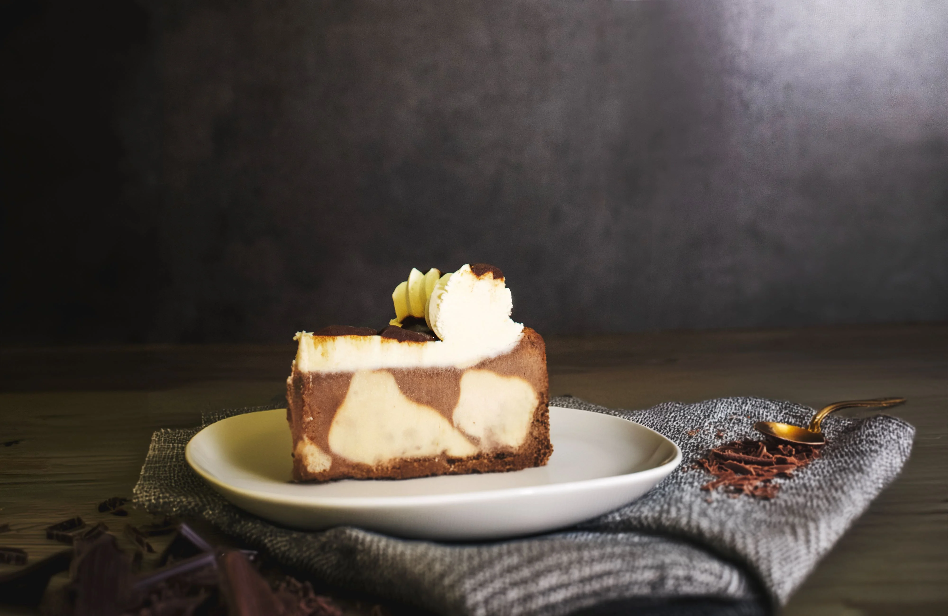 Decadent chocolate cheesecake slice on a white plate
