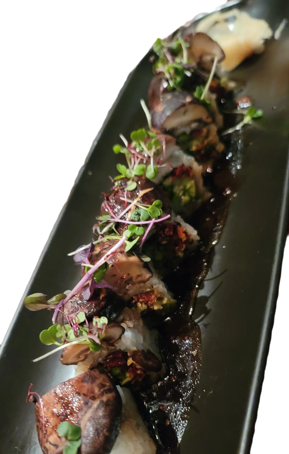 Artistic sushi roll with fresh toppings and sauce