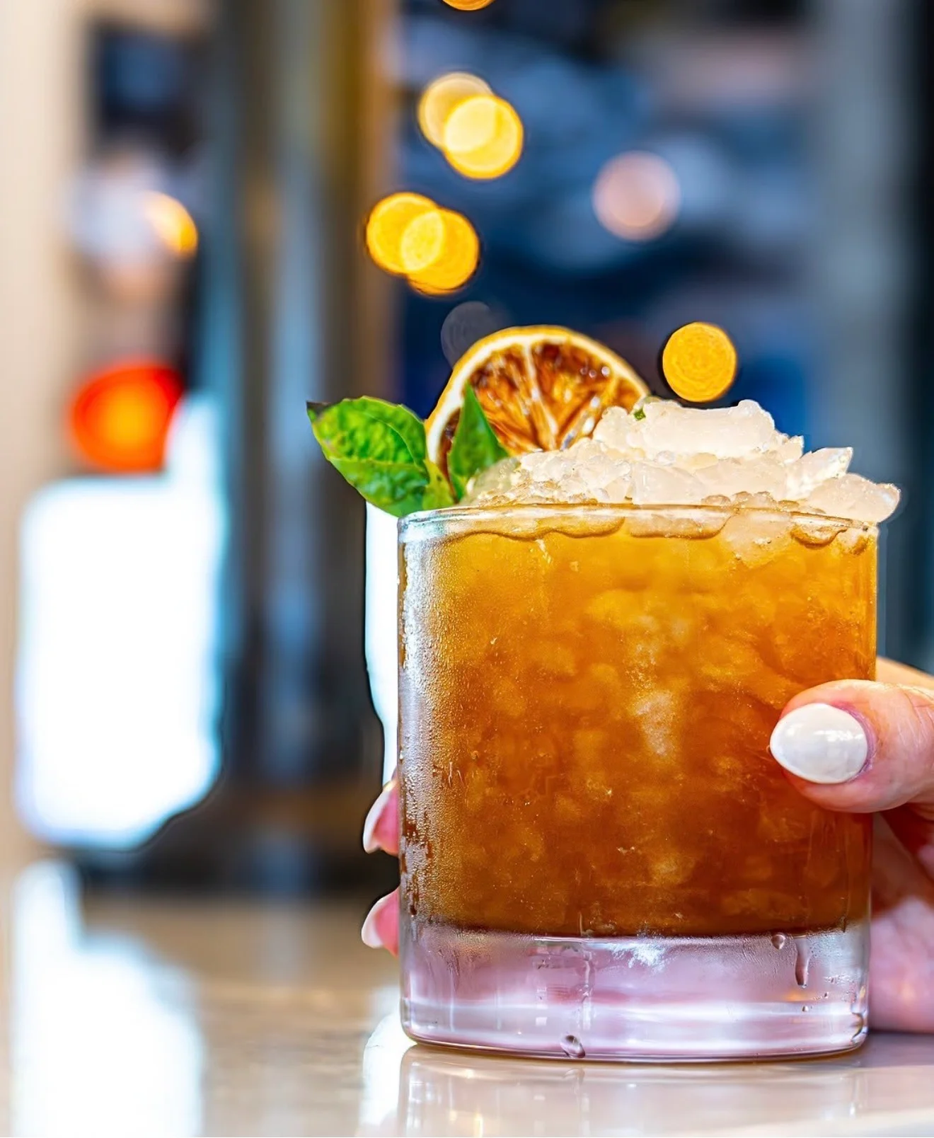 Refreshing cocktail with mint and dried citrus garnish