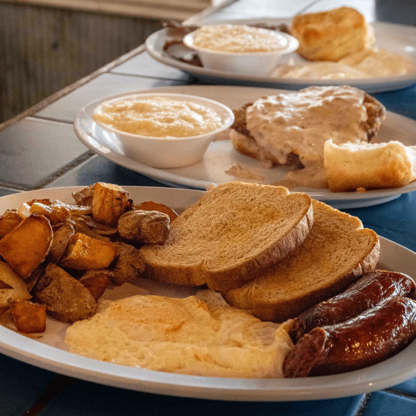 Southern breakfast platter with eggs, sausage, and grits