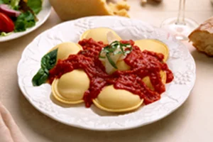Delicious ravioli topped with rich marinara sauce and fresh basil