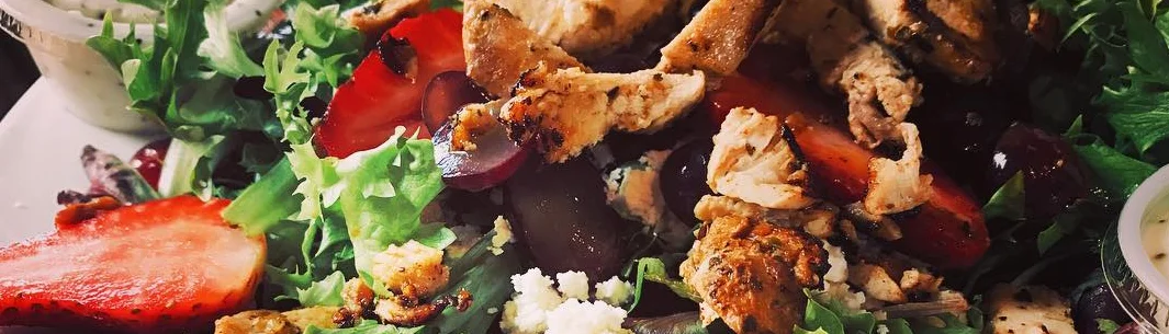 Grilled chicken salad with mixed greens and strawberries