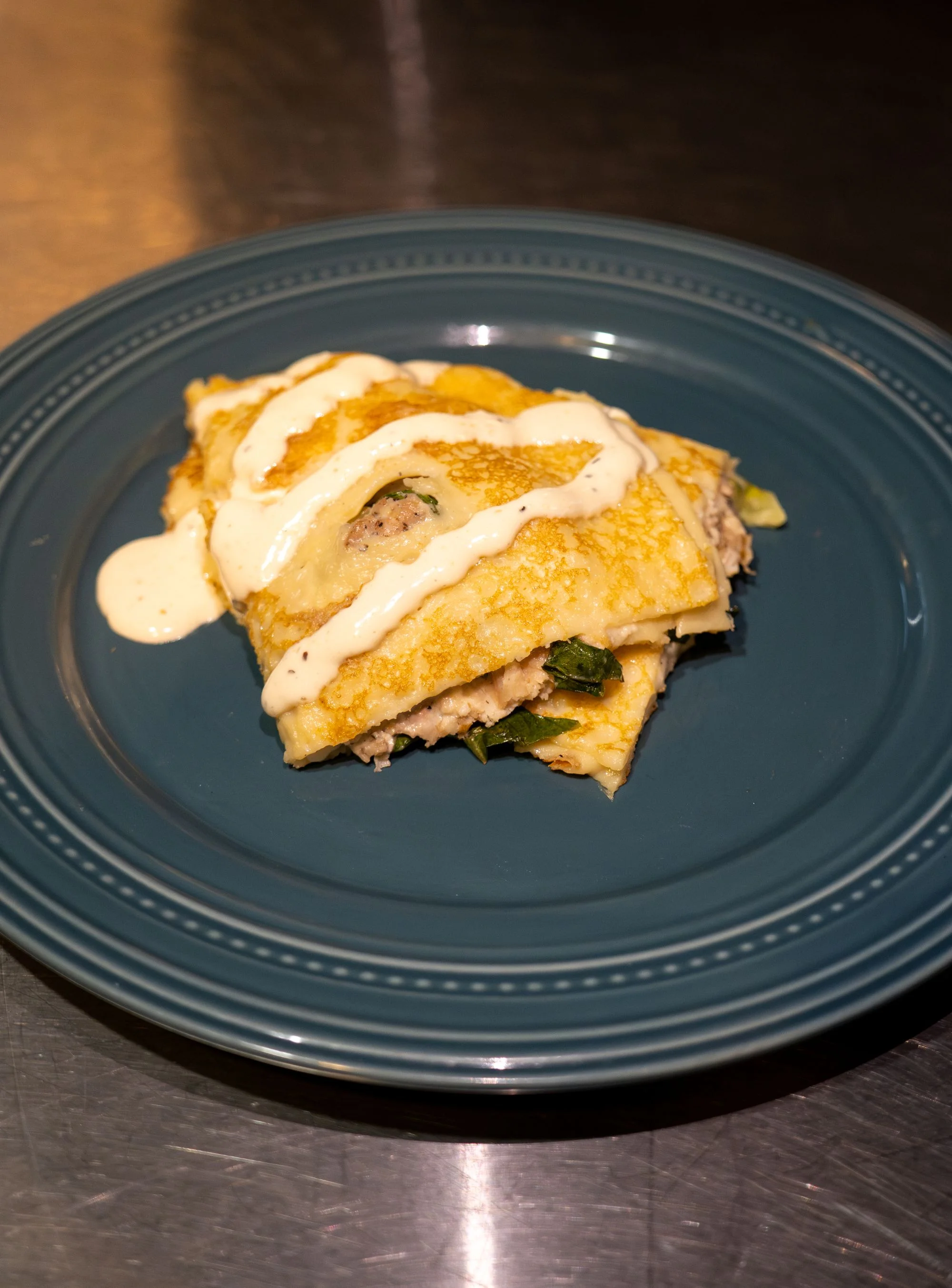 Savory Mexican enchiladas topped with creamy sauce
