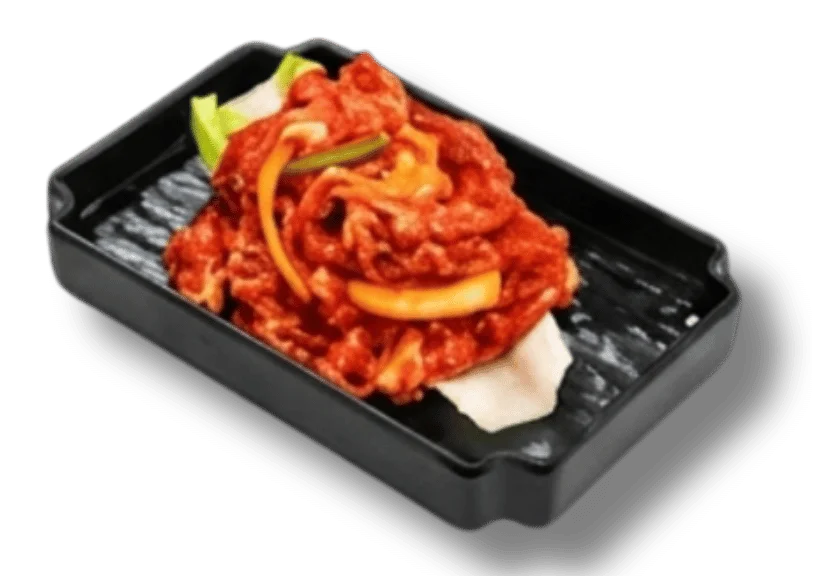 Plate of spicy beef with vegetables served on a black dish.