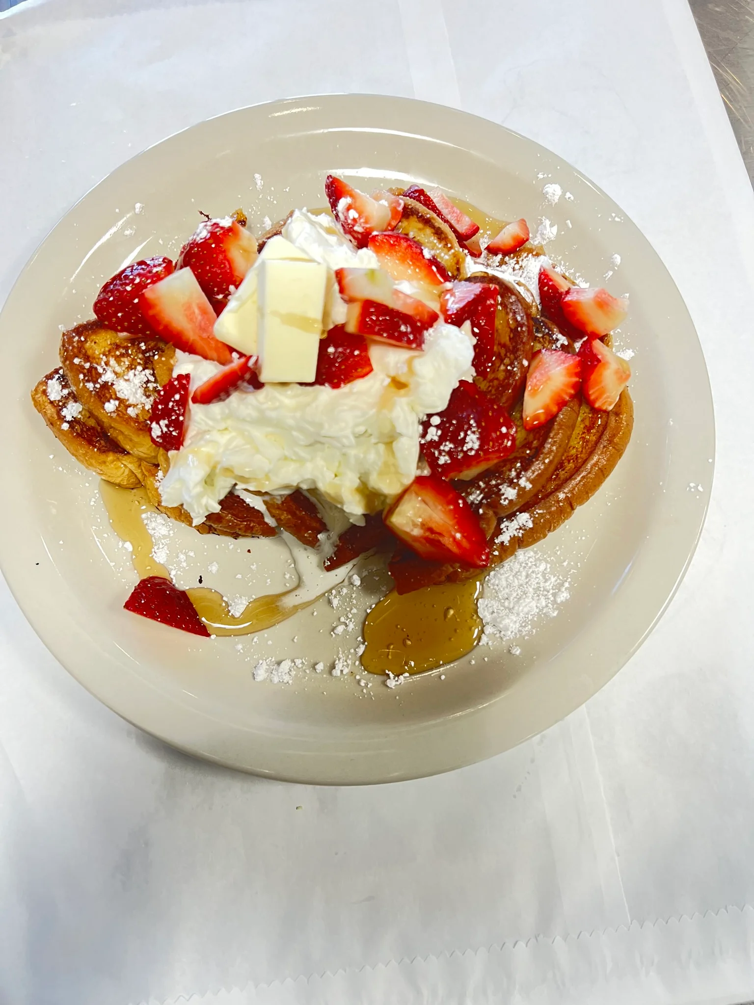 Delicious French toast topped with strawberries and whipped cream