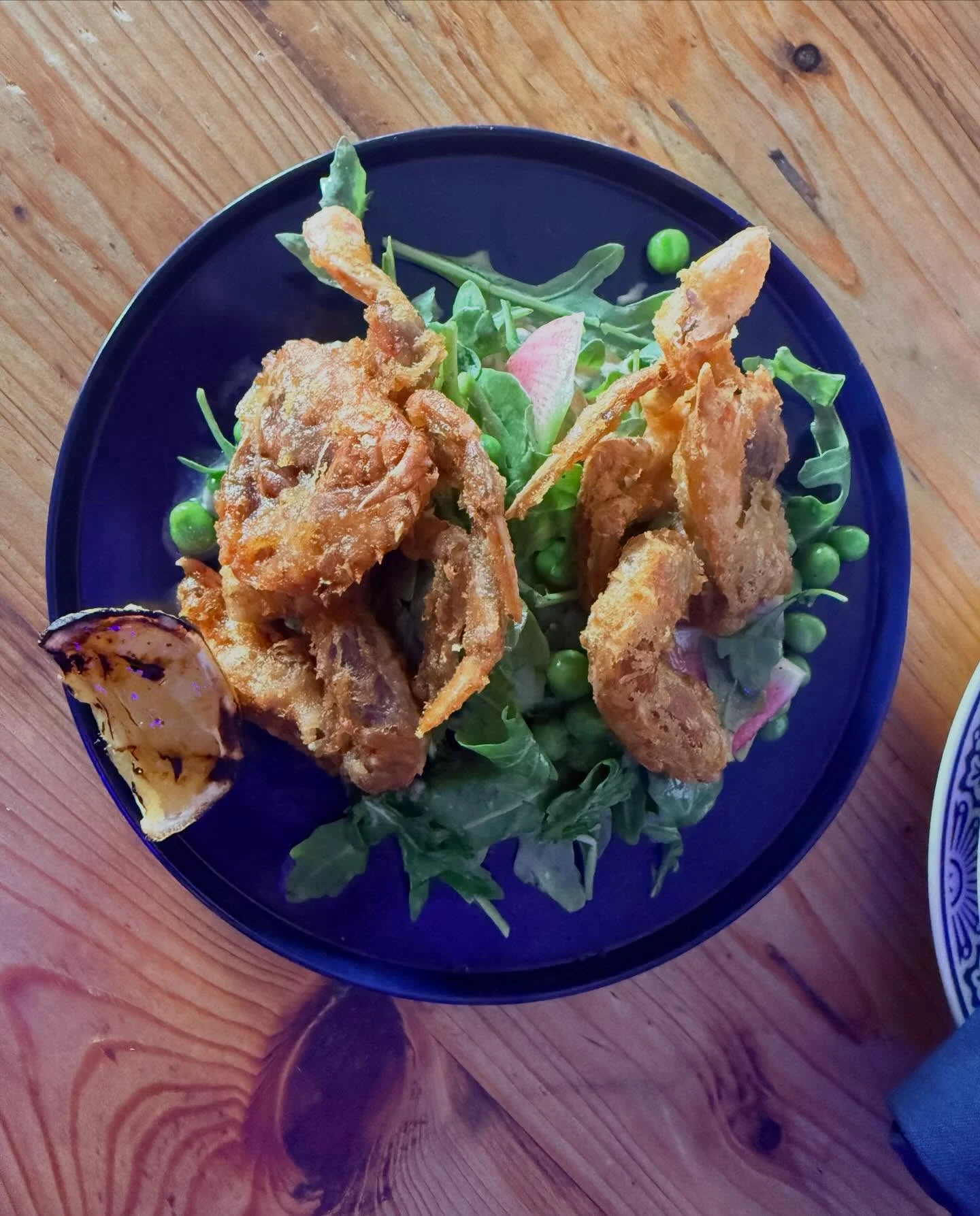 Crispy fried soft-shell crabs on a bed of arugula salad
