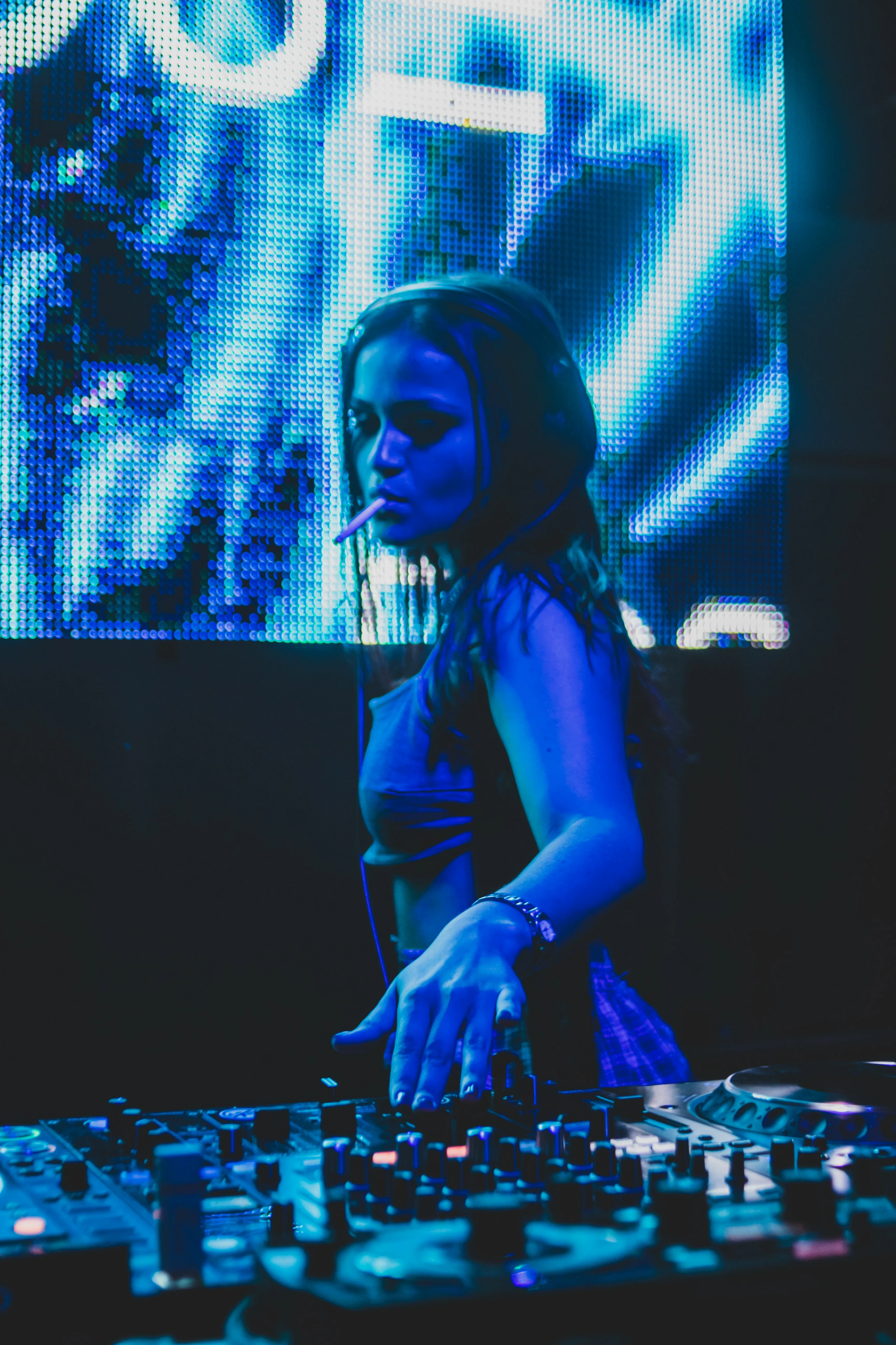 DJ performing at a vibrant nightclub with neon lights