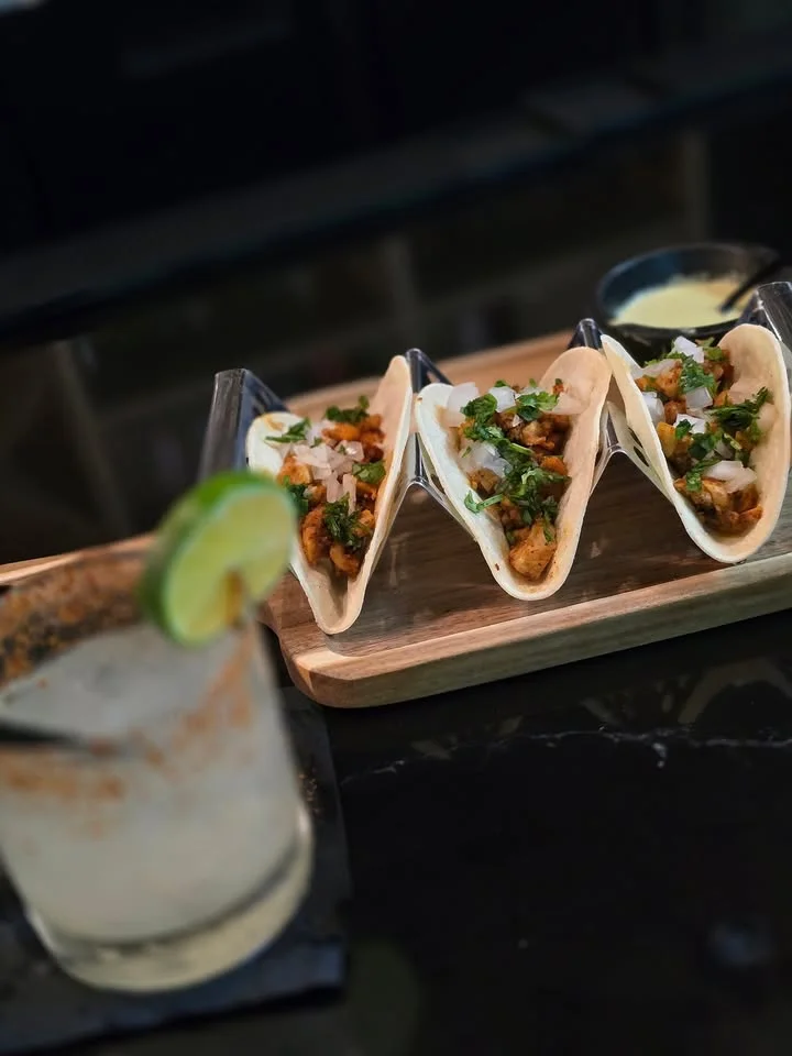 Three delicious tacos al pastor served with fresh toppings