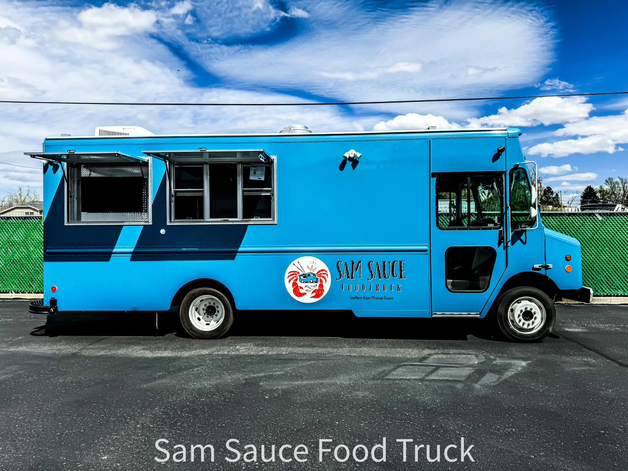 Bright blue food truck named Sam Sauce
