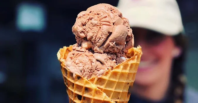 Chocolate ice cream cone with two scoops