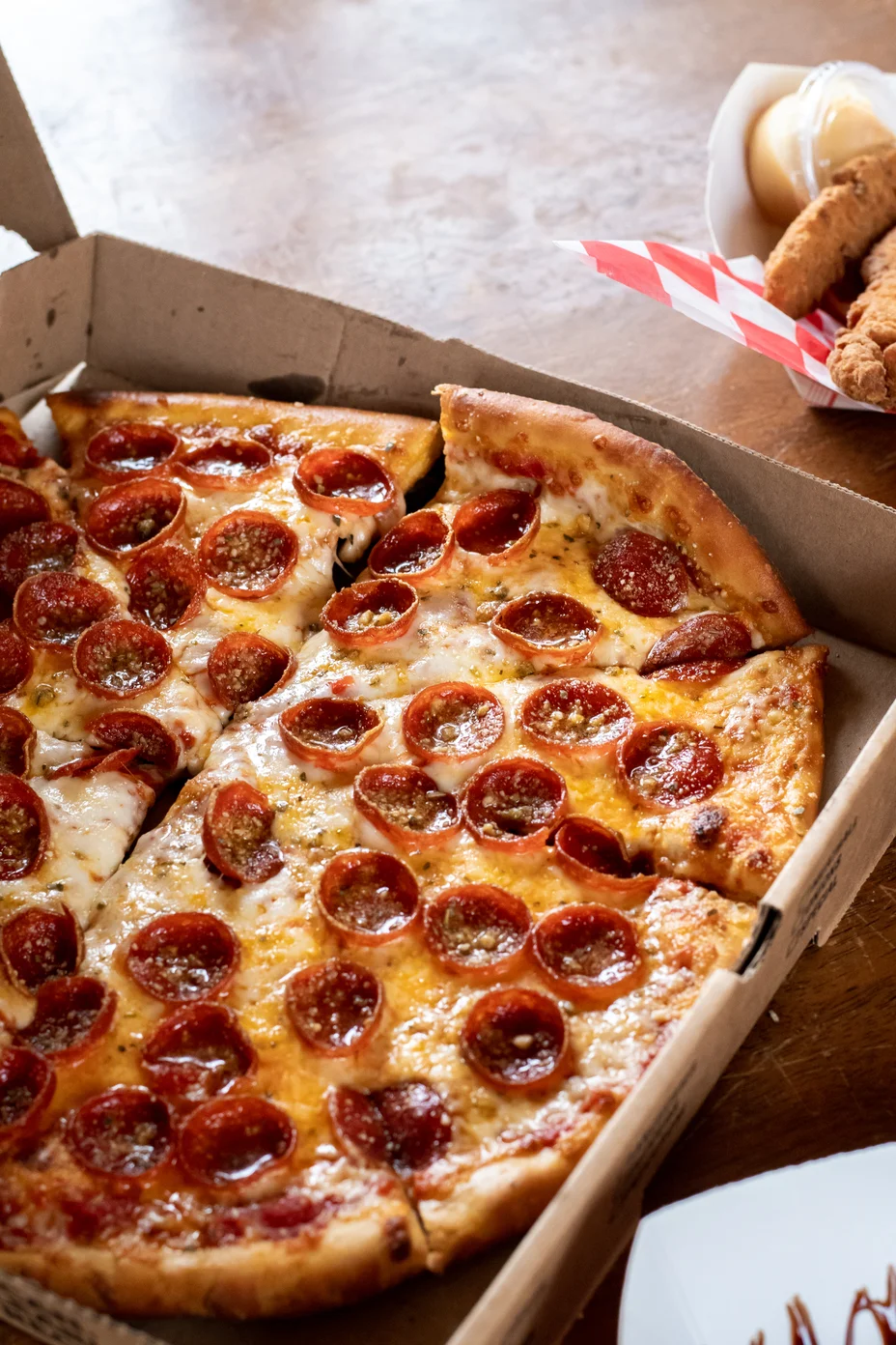 Pepperoni pizza in a takeout box