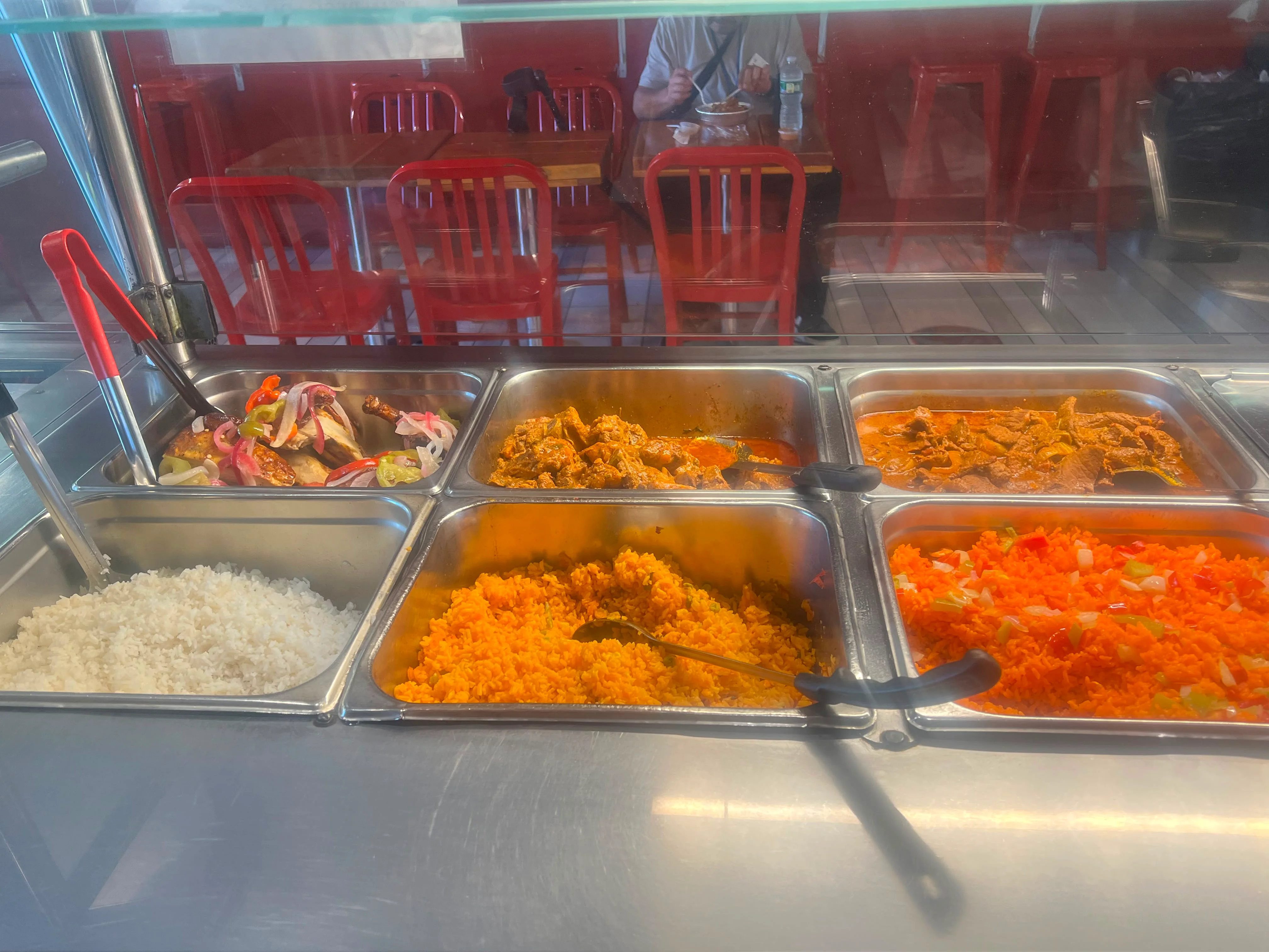 Nigerian jollof rice with assorted meats and sides