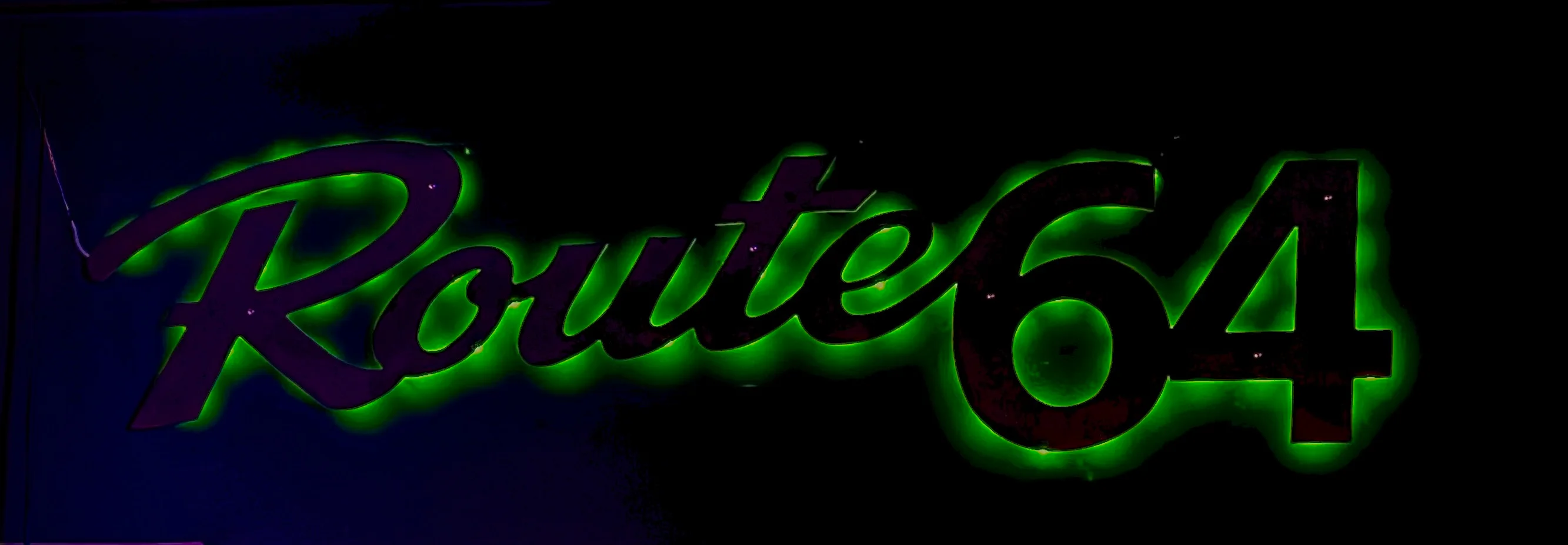 Illuminated Route 64 restaurant sign with green glow