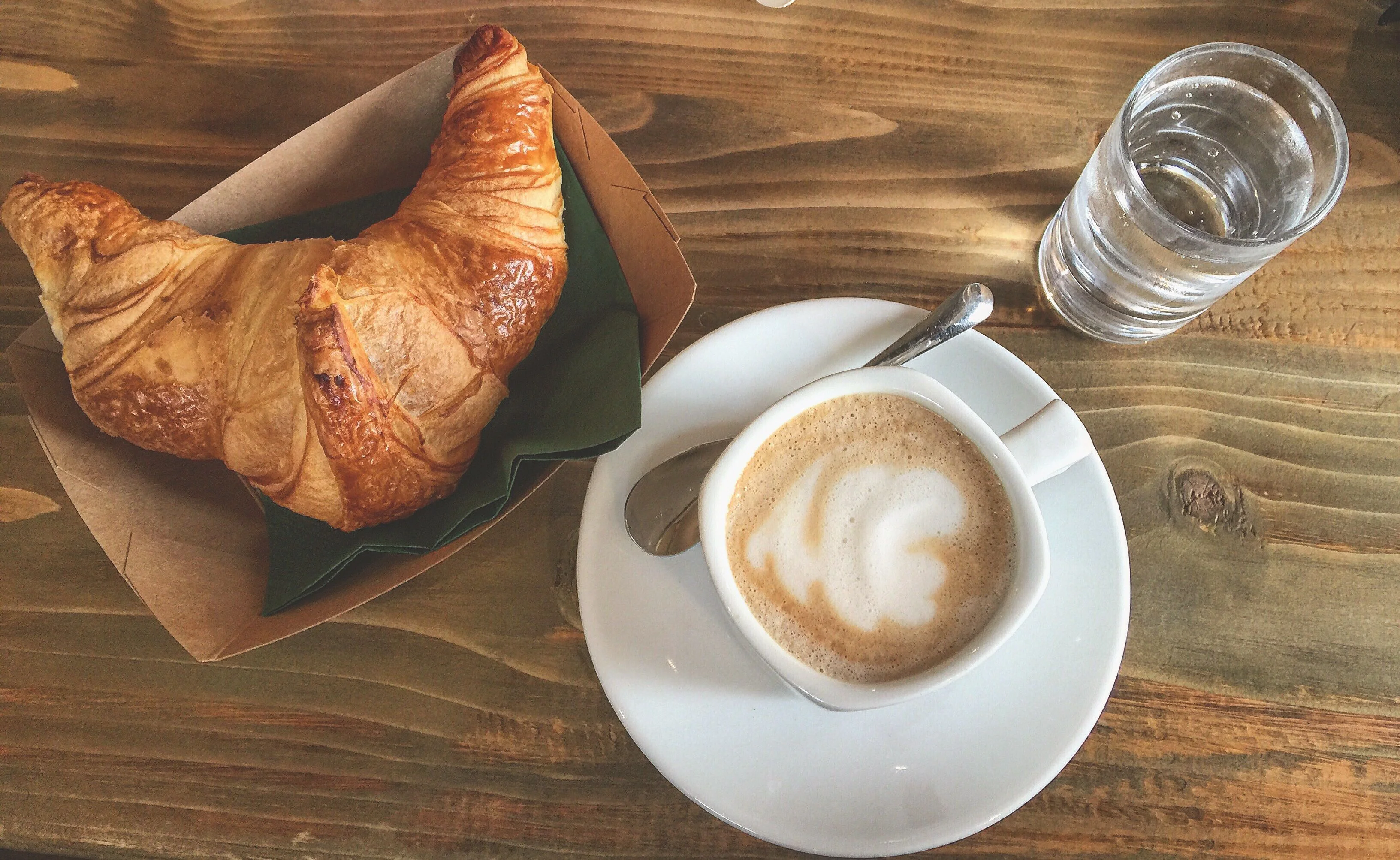 Freshly baked croissant with a cup of cappuccino