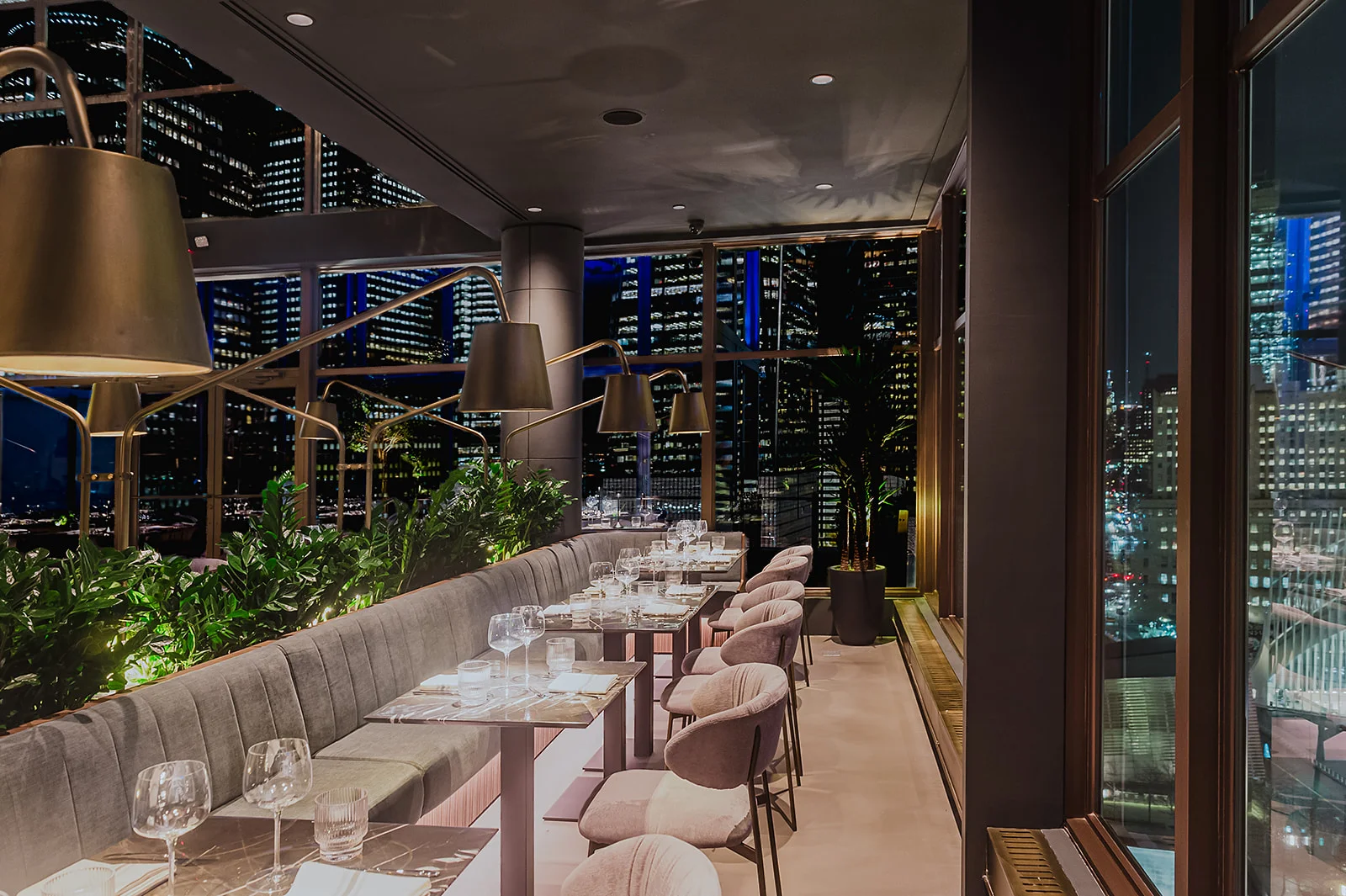 Elegant restaurant interior with city skyline views at night