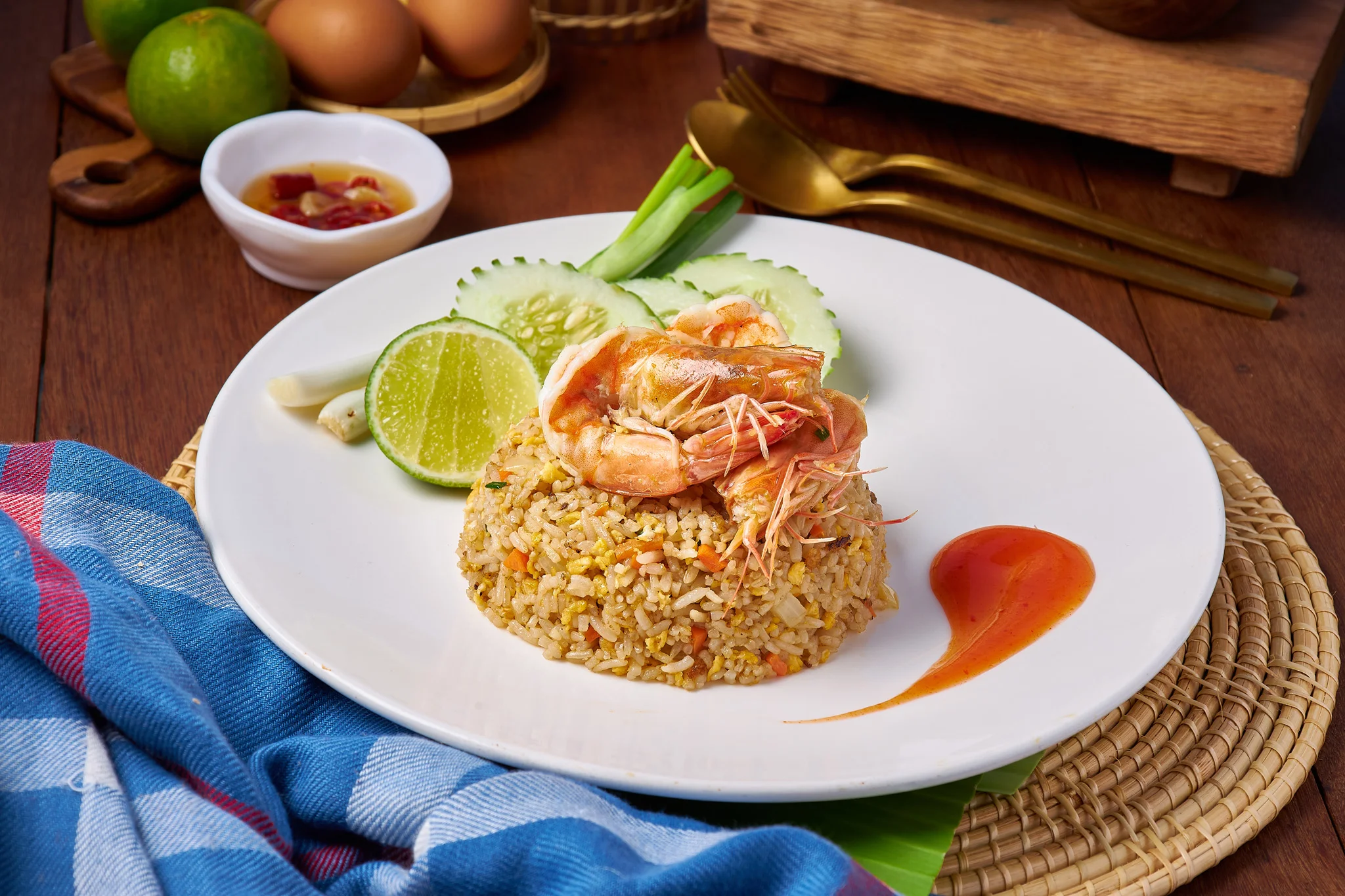 Thai shrimp fried rice garnished with lime and cucumber