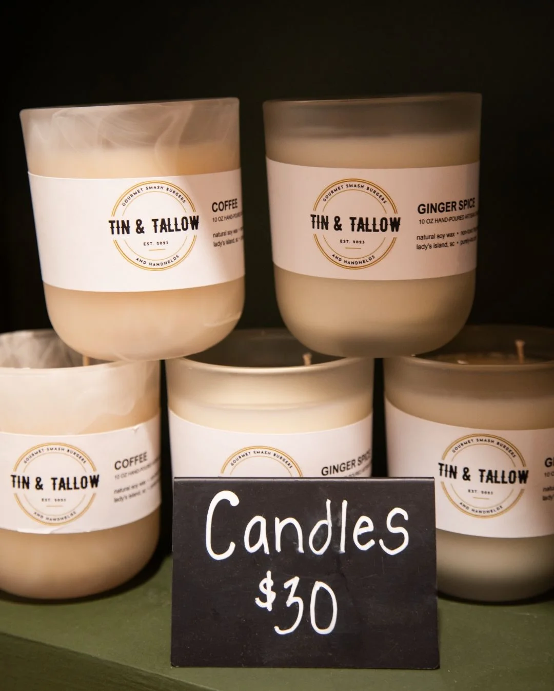 Hand-poured candles in various scents displayed for sale
