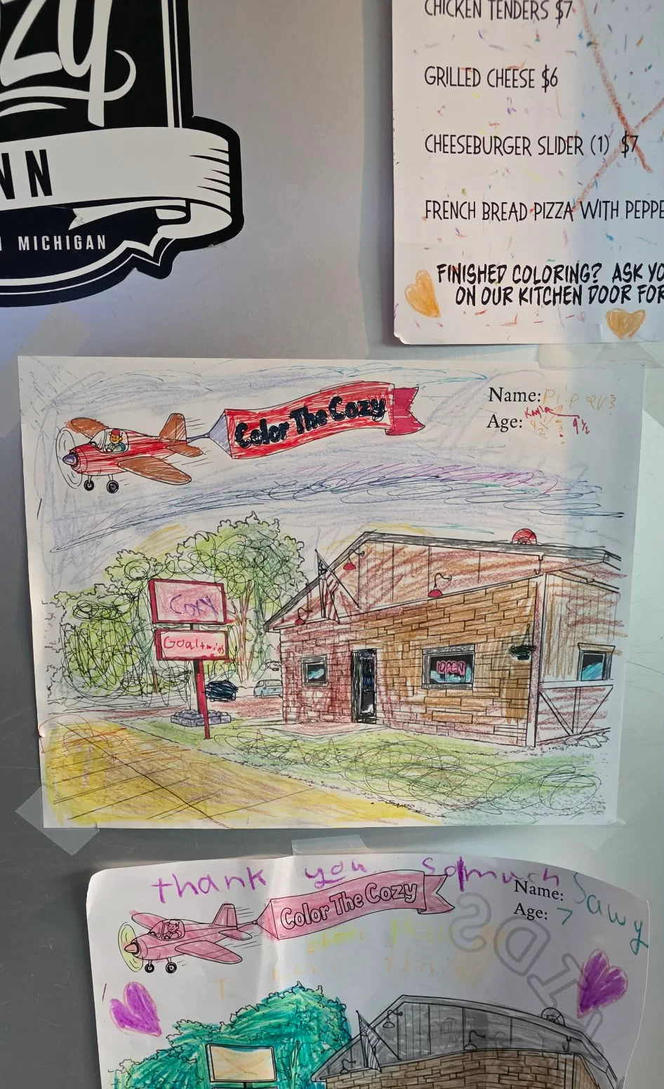 Colorful children's drawings of a restaurant with an airplane theme.