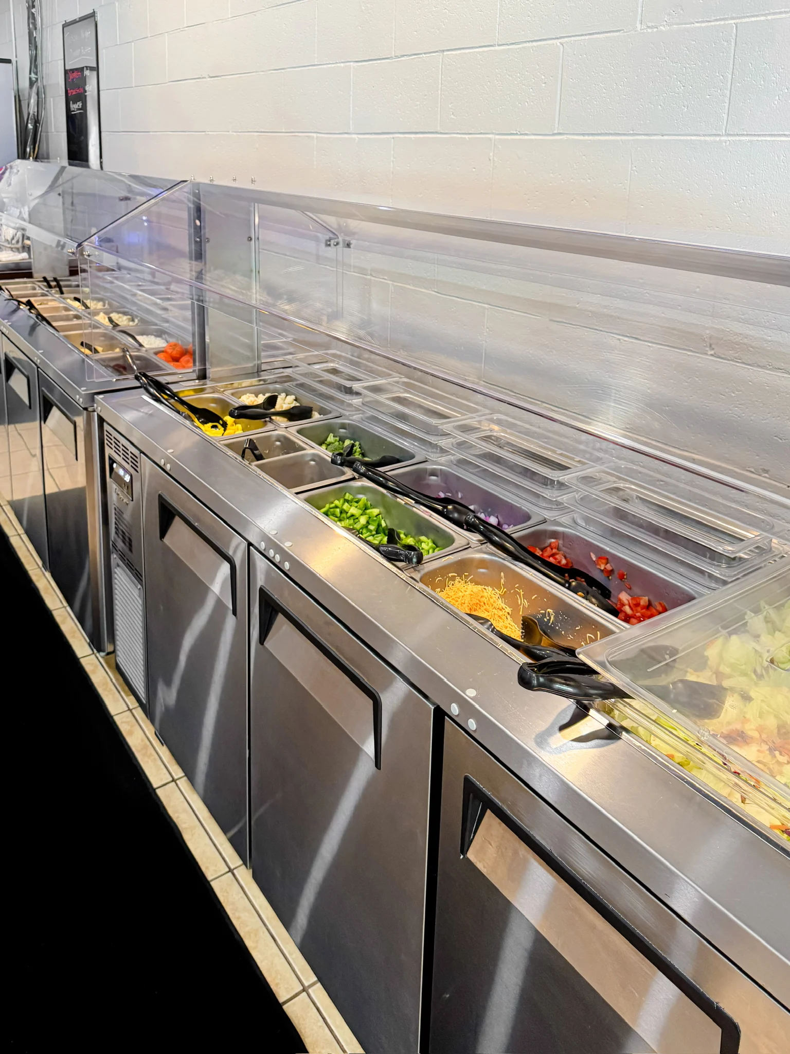 Salad bar with fresh toppings and ingredients