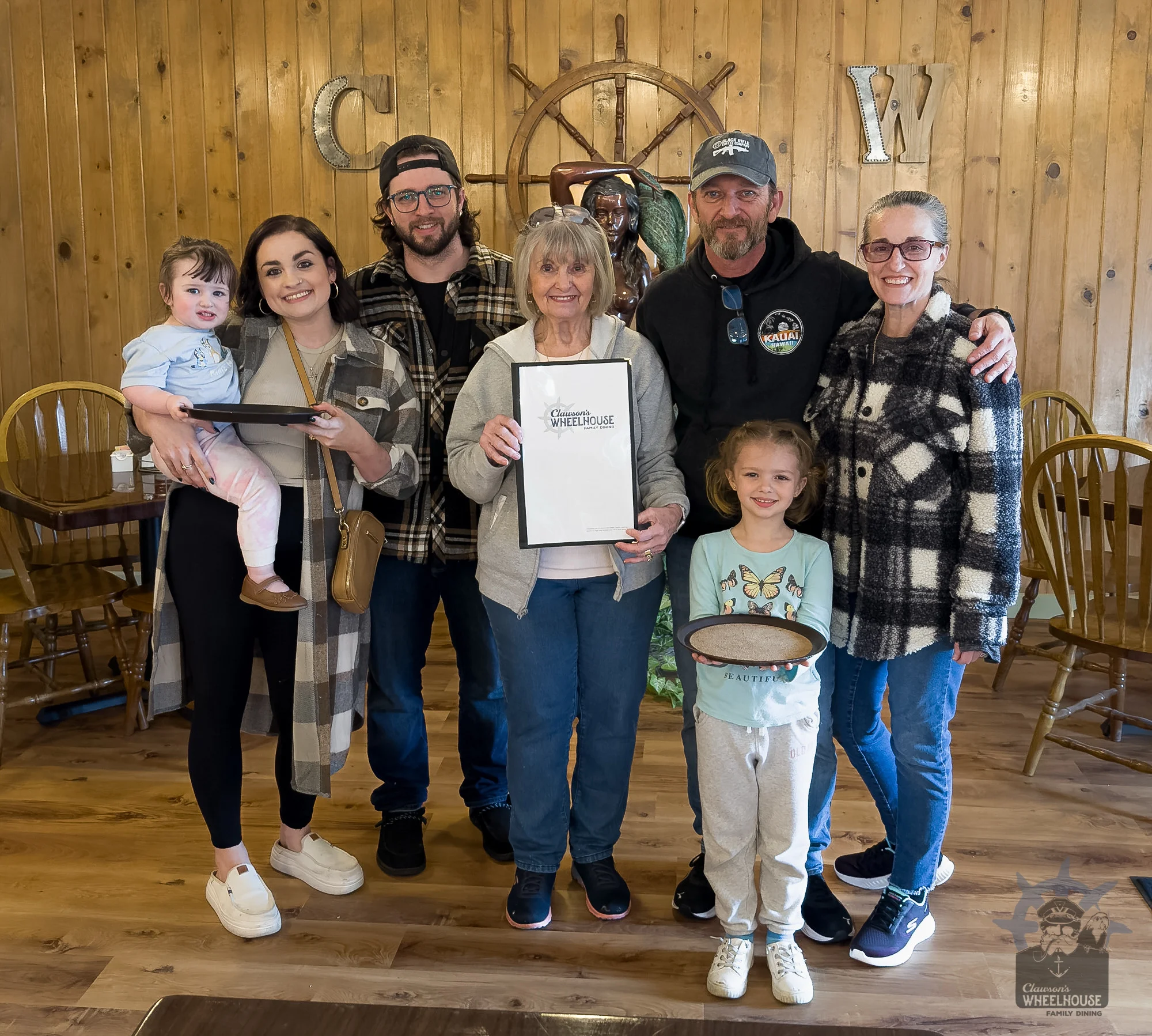 Family gathering at a cozy restaurant with warm wooden decor