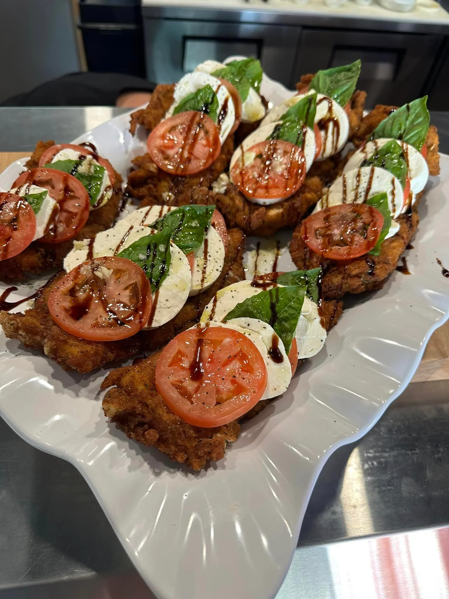 Crispy chicken caprese with fresh basil and balsamic drizzle