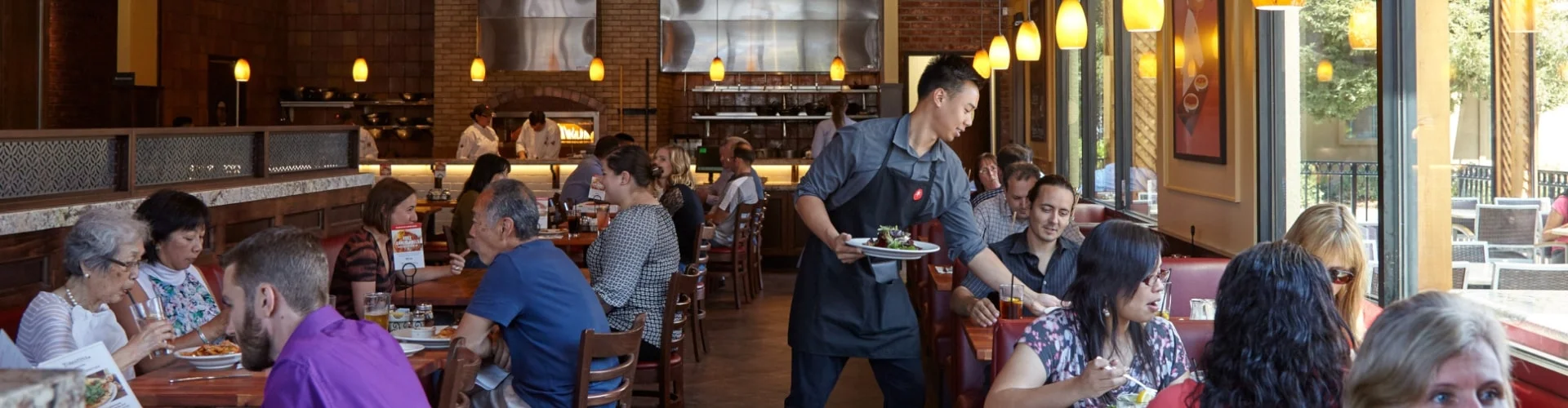 server running food to guests in restaurant