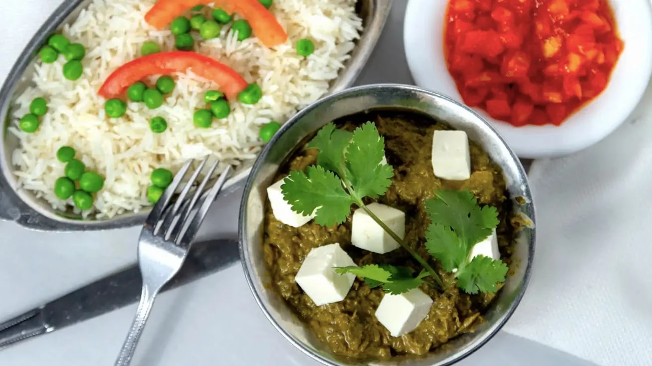 Palak paneer with white rice and peas.  