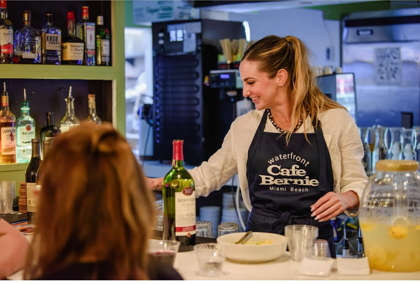 Bartender serving drinks at a vibrant Miami Beach bar