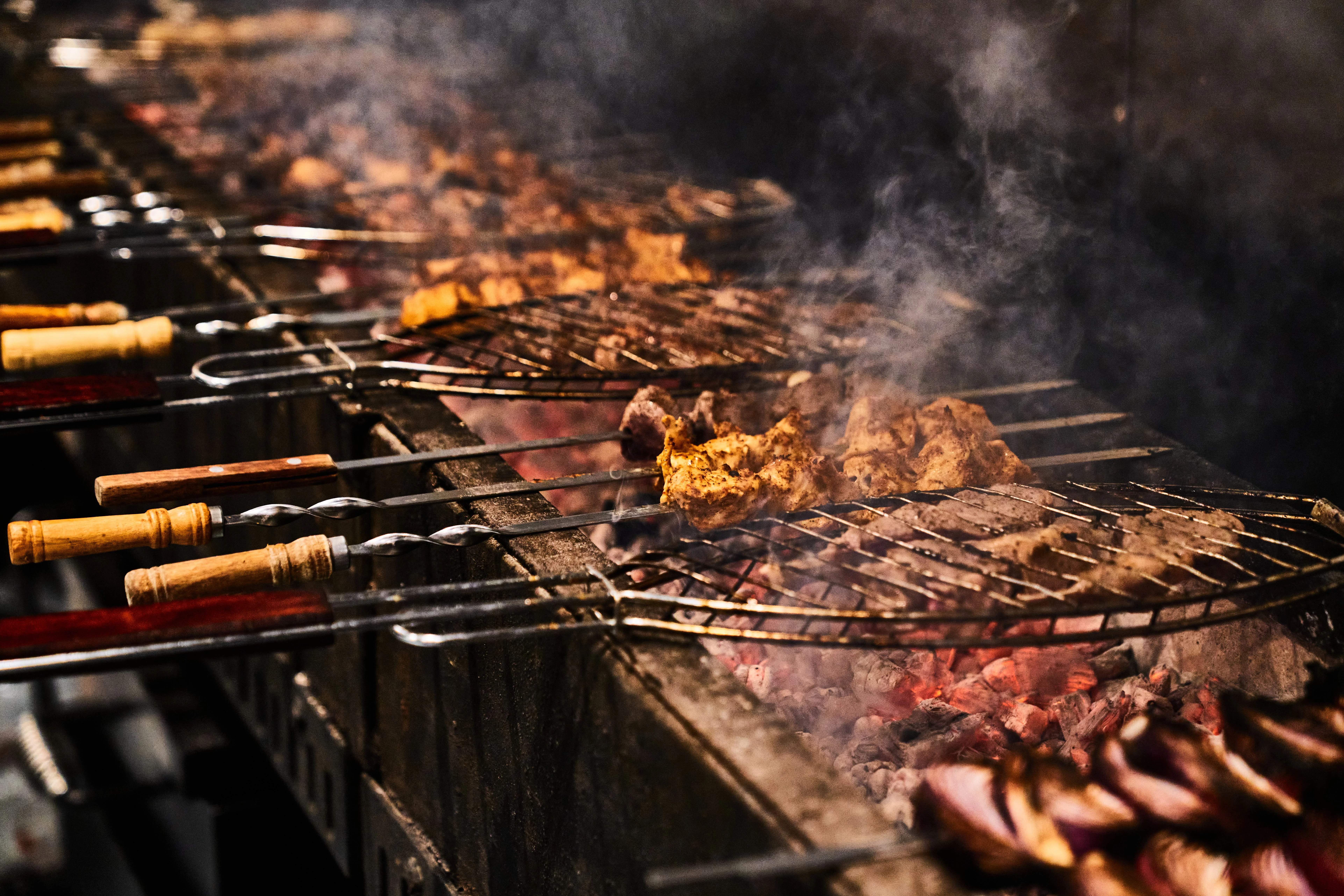 Meat grilling over charcoal