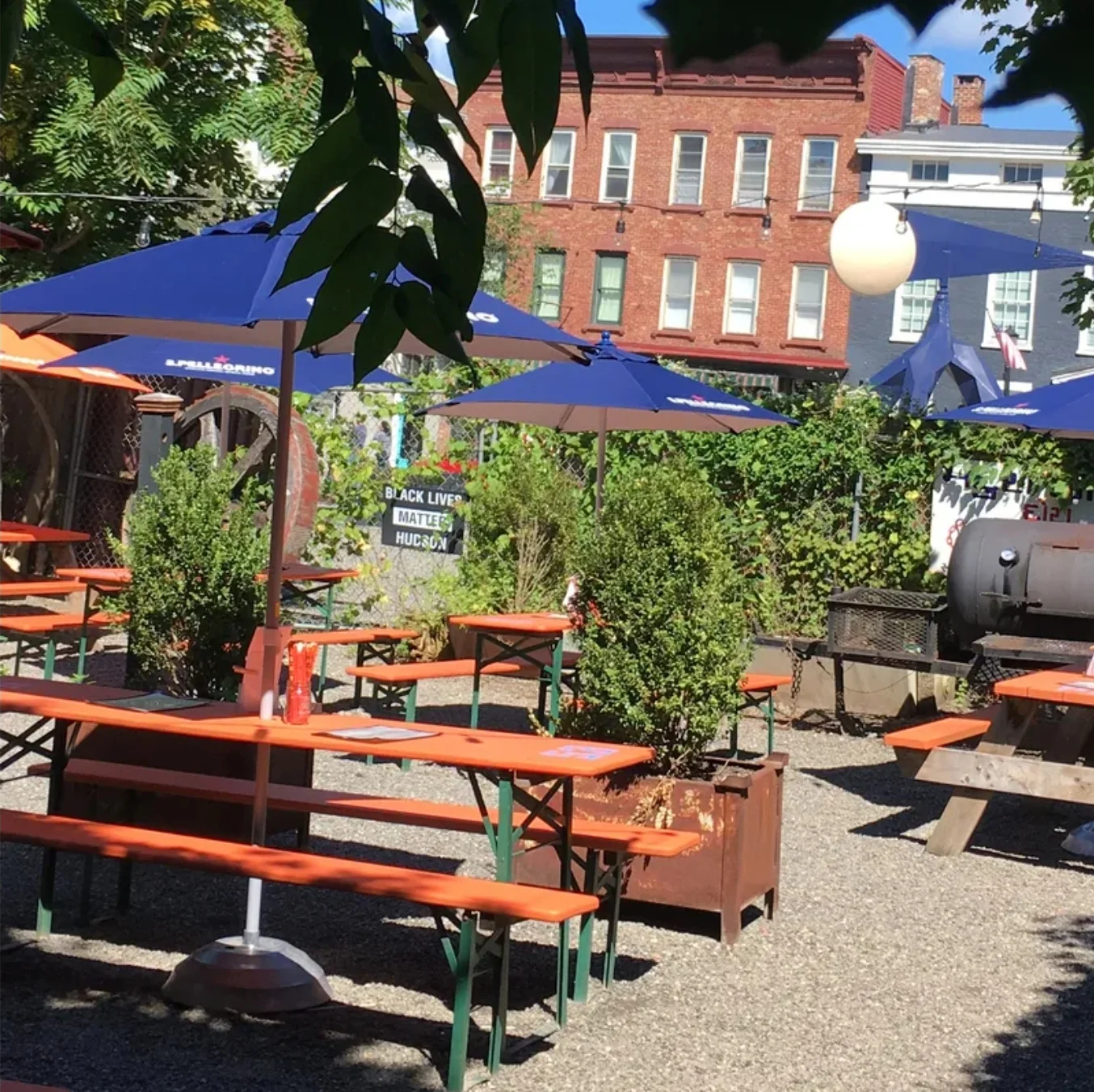Outdoor dining area with colorful umbrellas and picnic tables