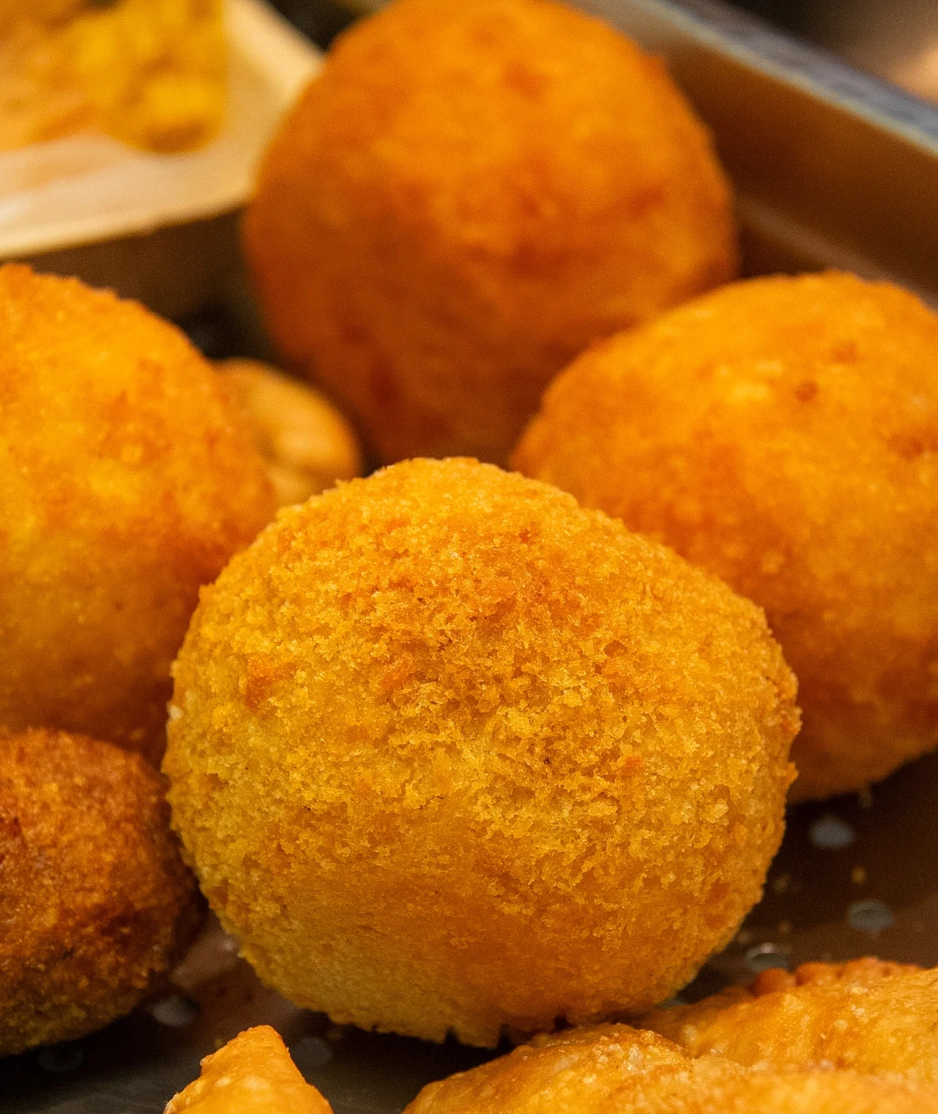 A close-up view of golden fried balls, likely a popular snack or appetizer.